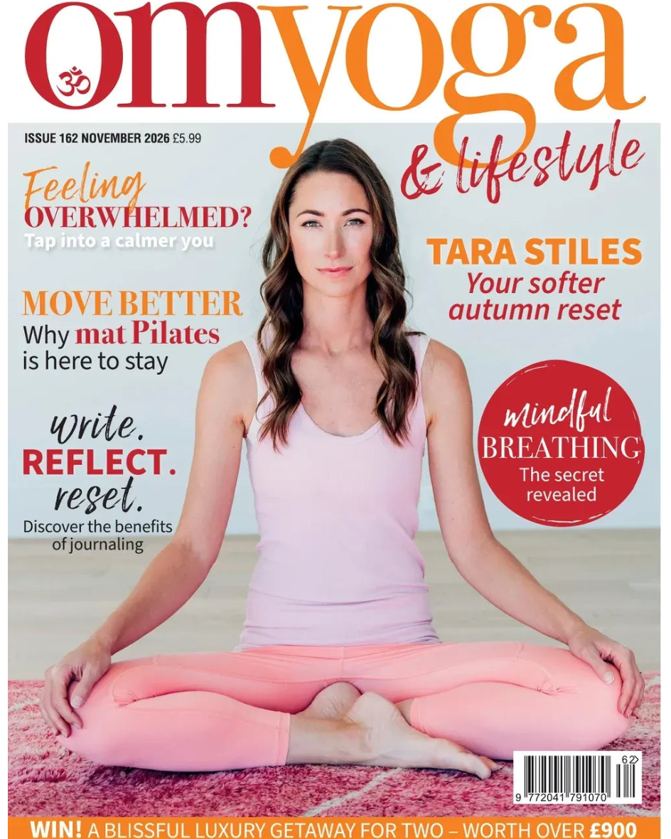 Omyoga & Lifestyle magazine cover, Issue 152 November 2026, featuring a woman in a light pink tank top and pink leggings sitting cross-legged on a pink rug, with various article titles around her.